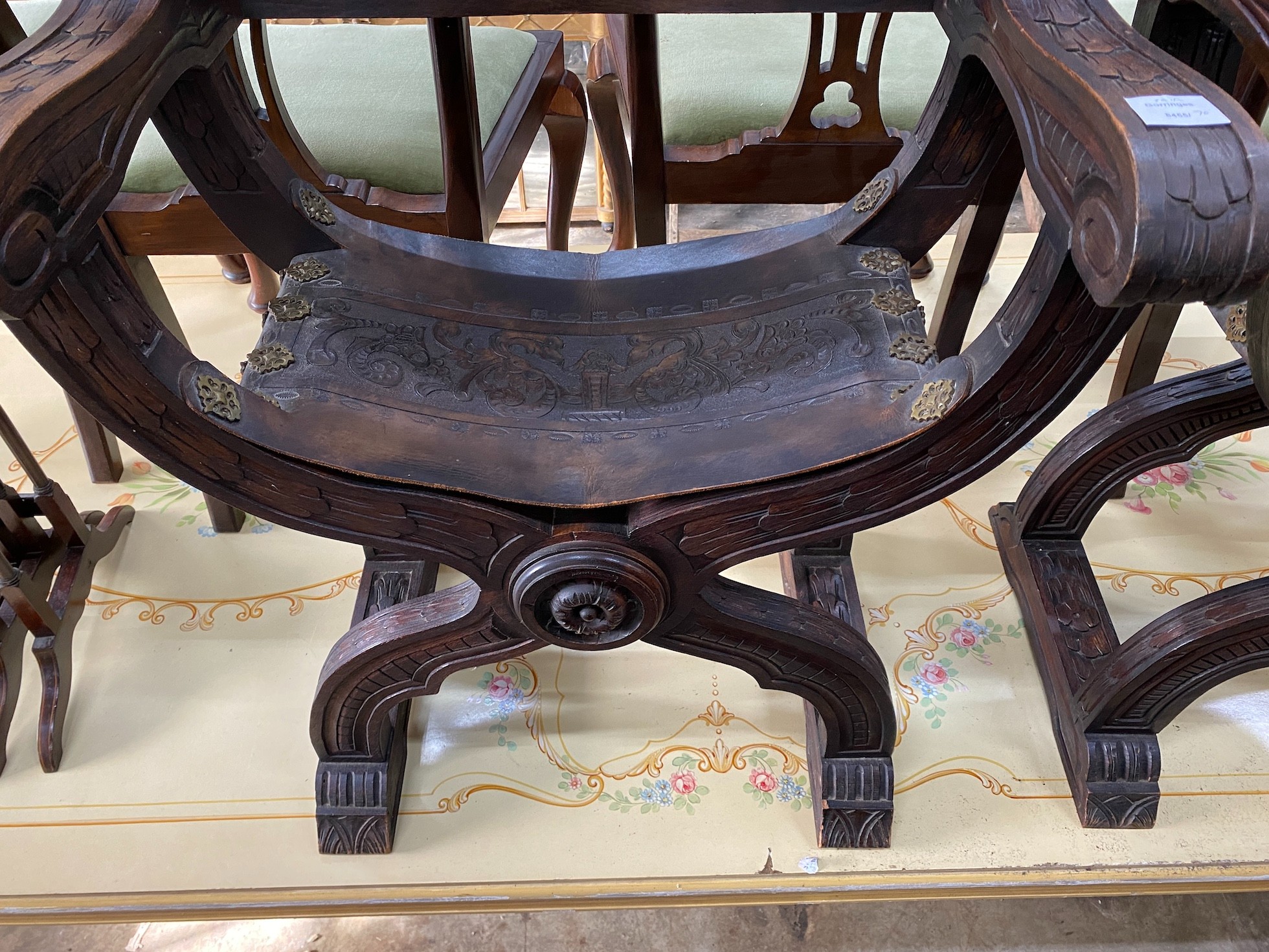 A pair of 19th century Spanish embossed leather and carved walnut framed 'X' framed armchairs, width 68cm, depth 42cm, height 76cm